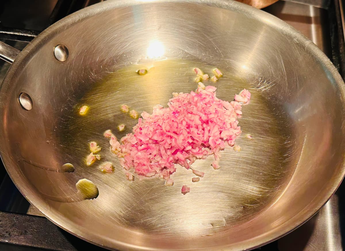 Minced shallot and olive oil in a small steel skillet.