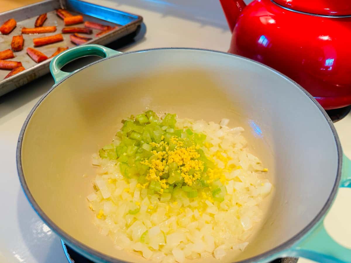 Onions, celery, and ginger in a pot.
