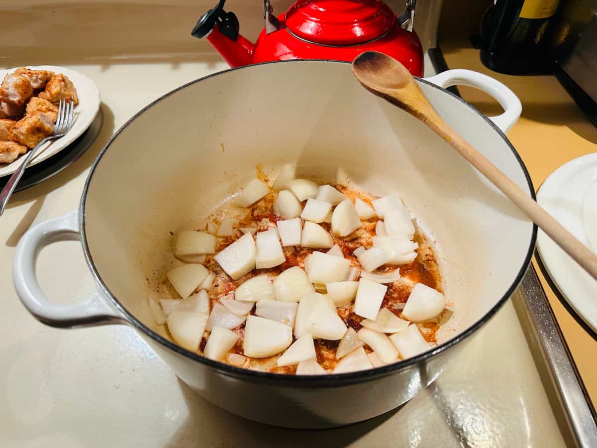 Chopped onions in a white pot.
