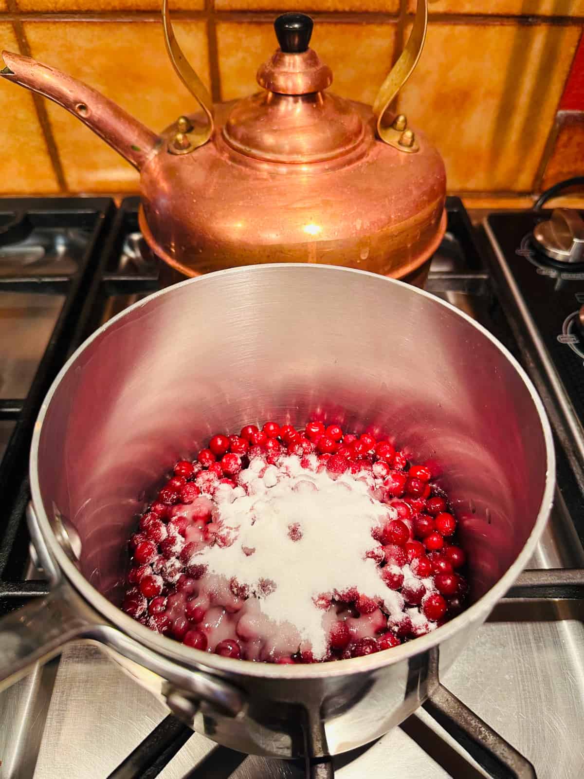 Lingonberries and sugar in a small saucepan.