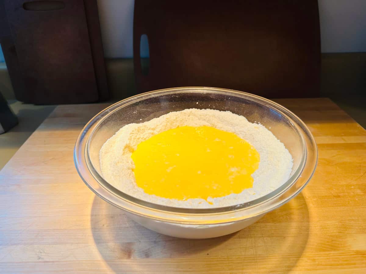 Dry ingredients and wet ingredients together in a glass bowl.