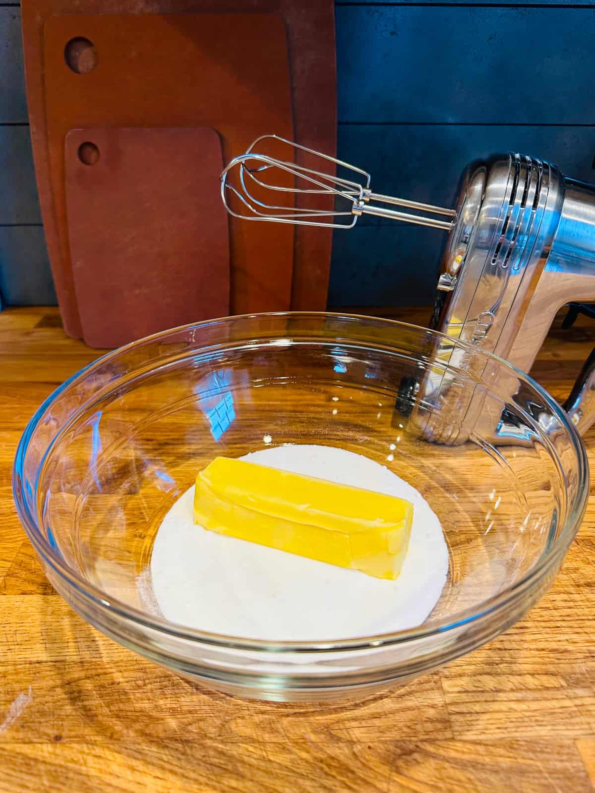 Butter and sugar in a glass bowl with electric mixer