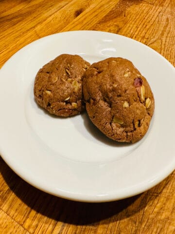 Two chocolate oatmeal cookies on a white plate