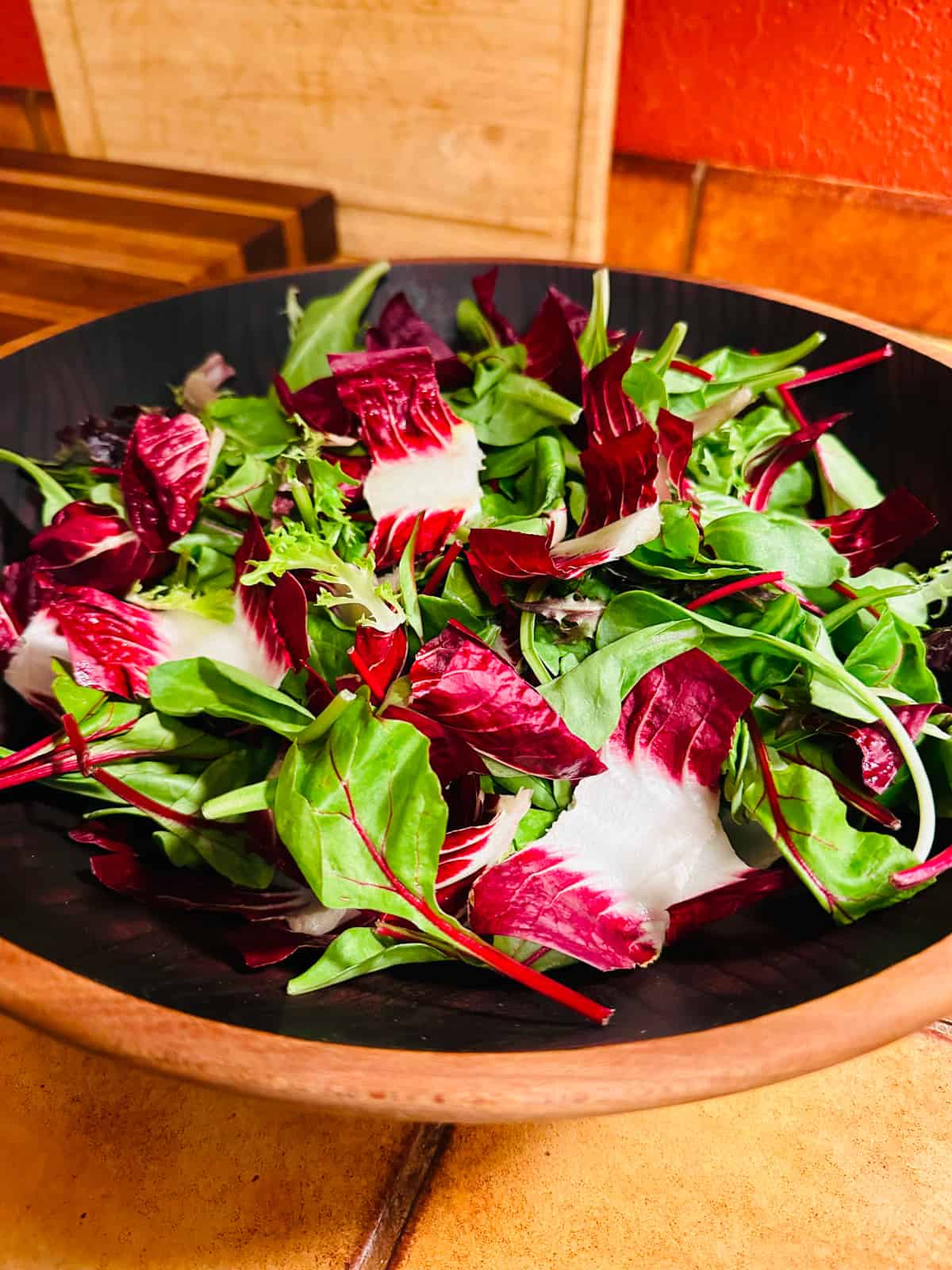 Treviso and baby lettuce in a wooden salad bowl.