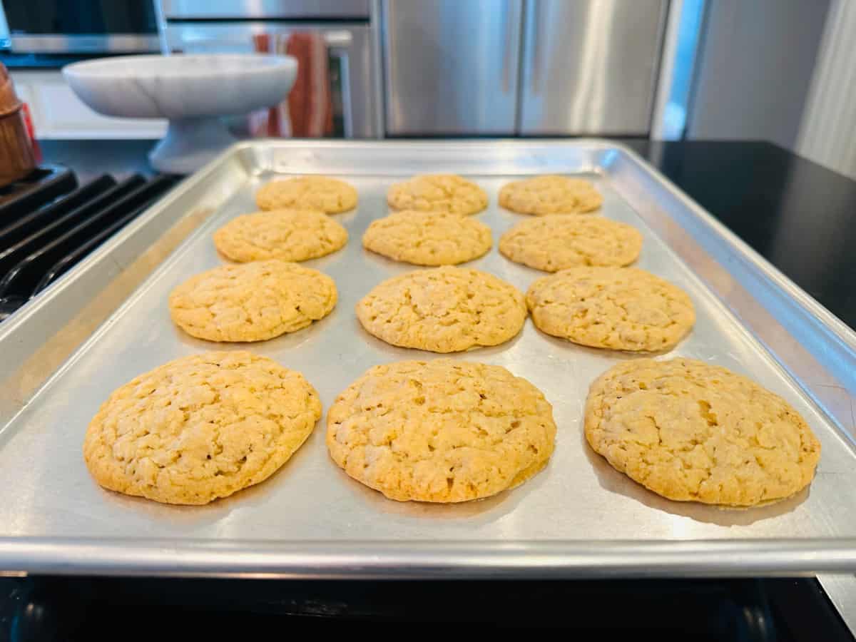 Baked cowboy cookies on a metal cookie sheet.