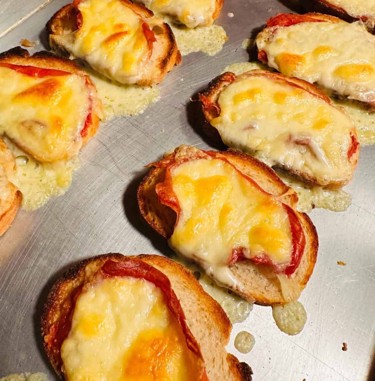 Finished toasts on a metal baking sheet.