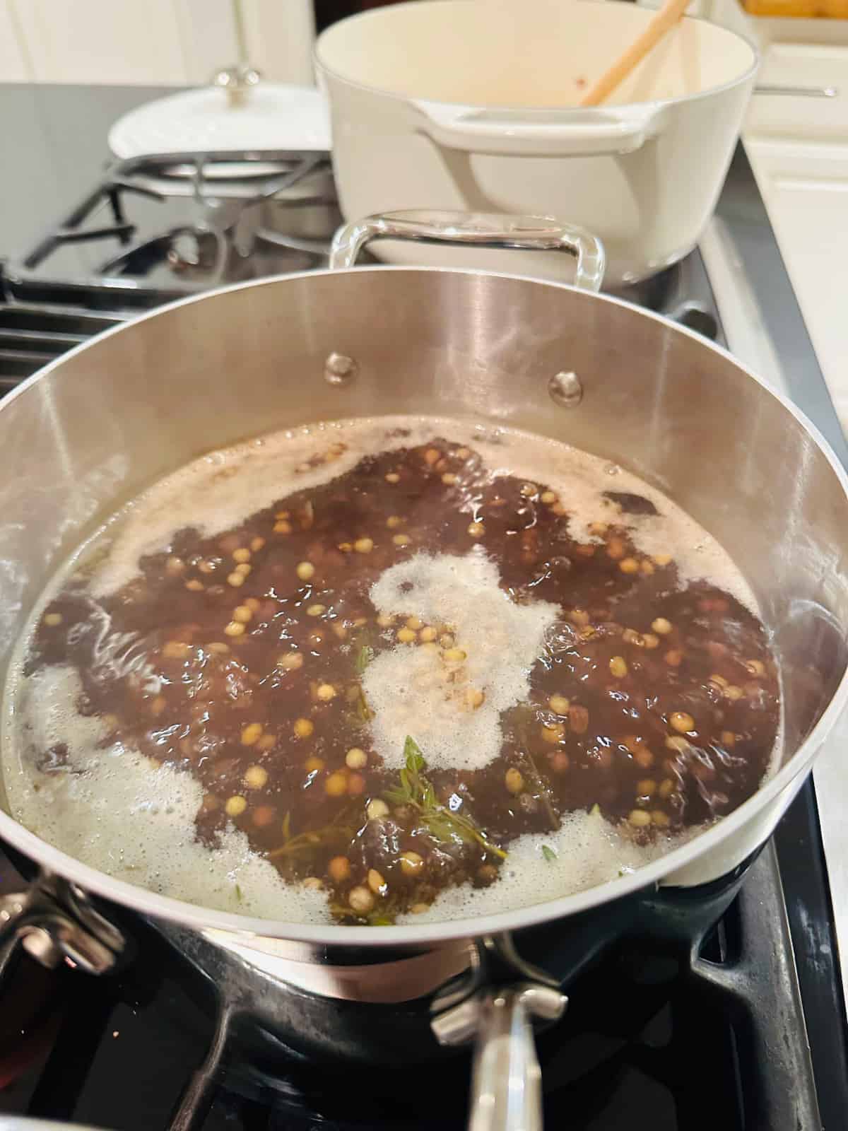 Lentils cooking in a steel pot.