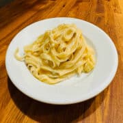 A serving of gorgonzola dolce with tagliatelle on a white plate.
