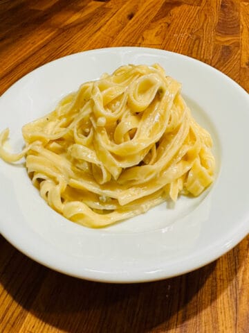 A serving of gorgonzola dolce with tagliatelle on a white plate.