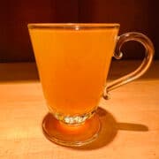 Golden colored liquid in a glass mug.