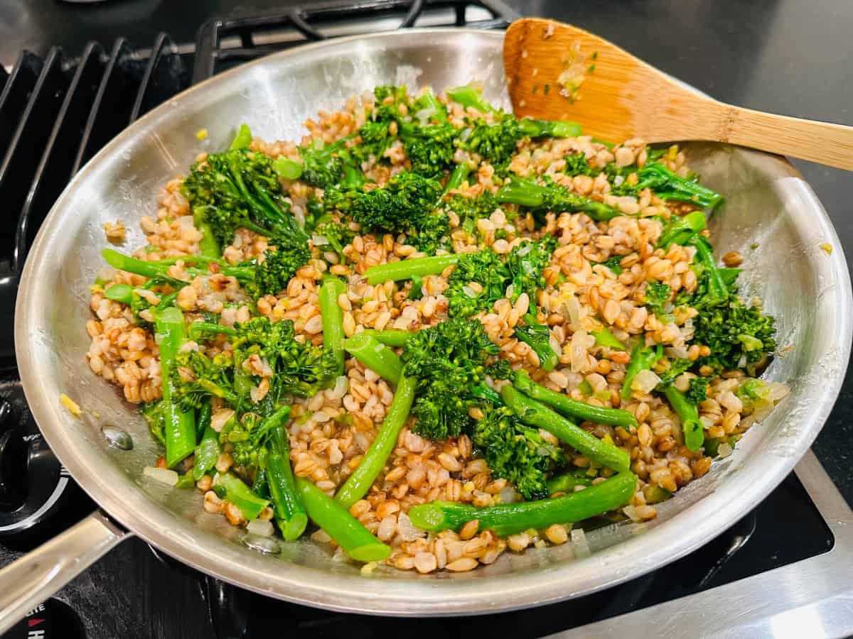 Barley and broccolini in a large skillet.