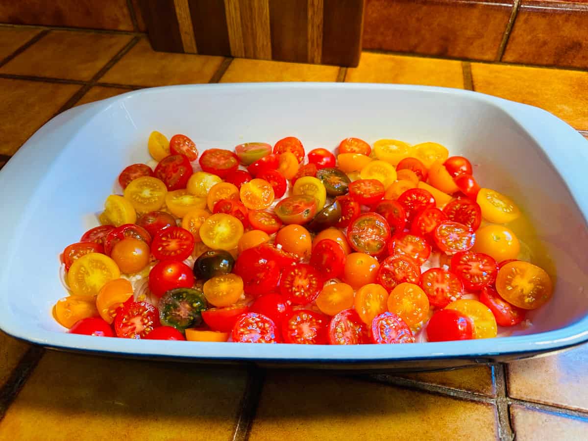 Tomato and shallot mixture in a large white baking dish.