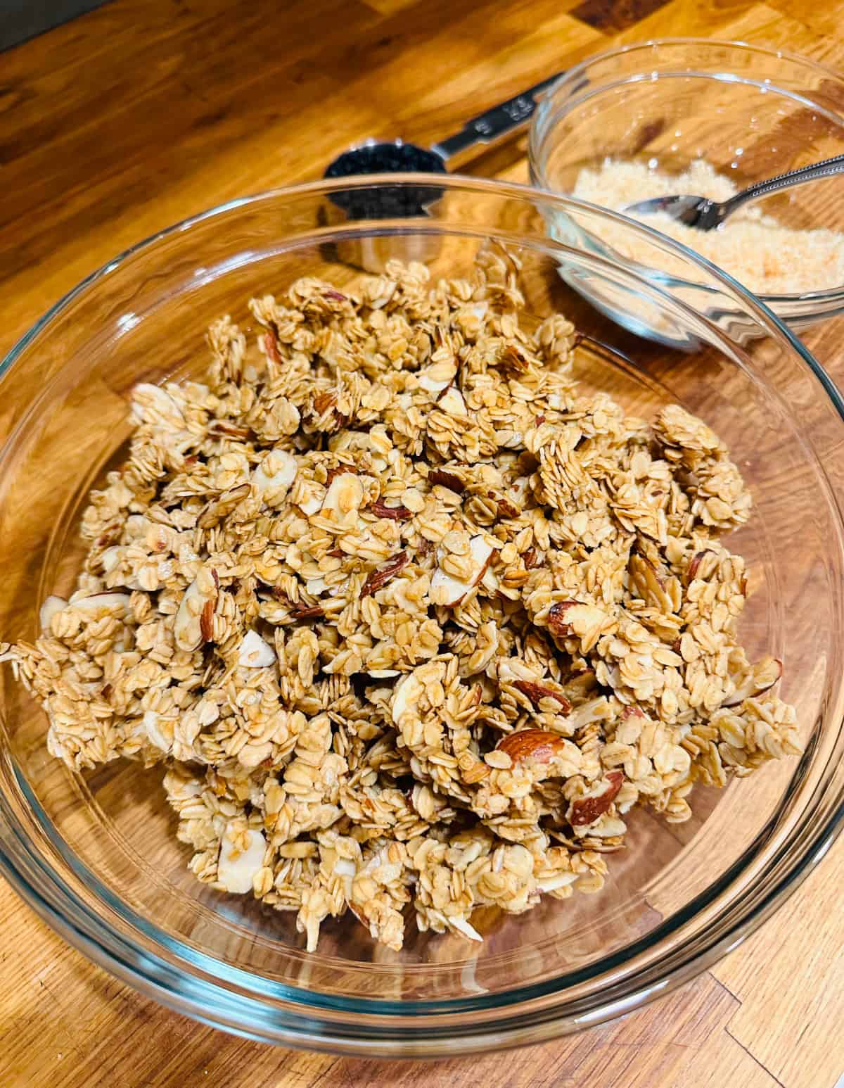 Chunks of granola in a glass bowl.
