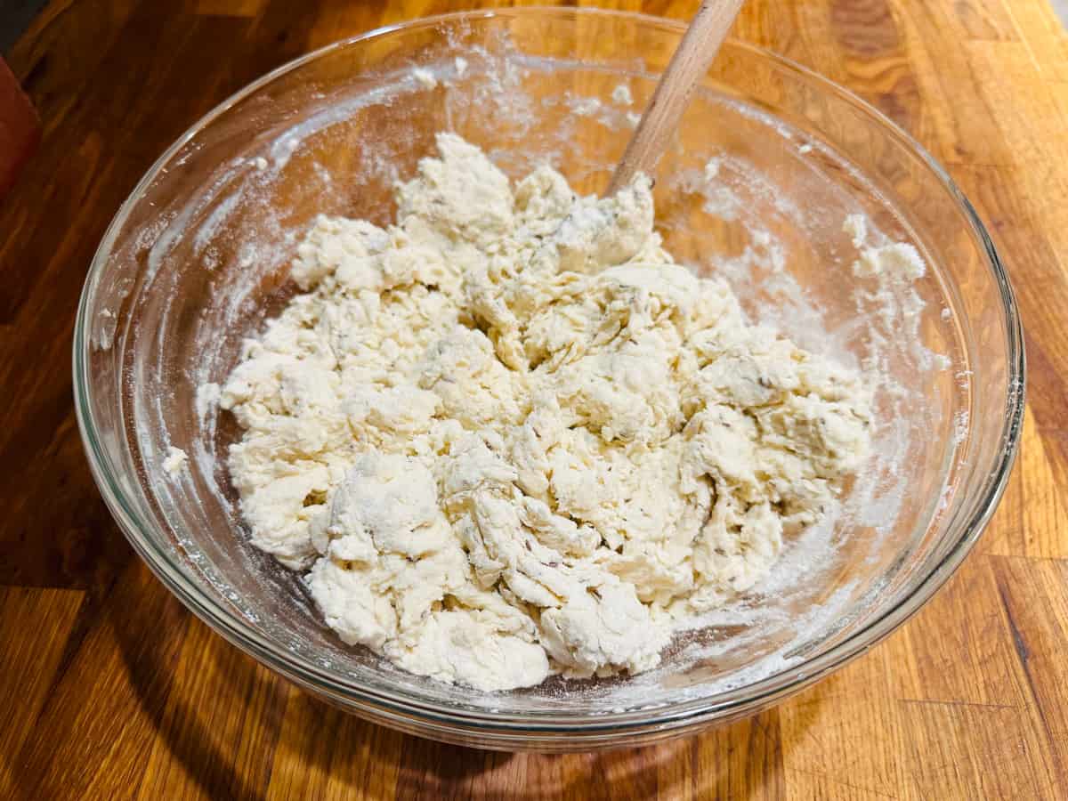 Rough clumps of pale yellow dough in a glass bowl.