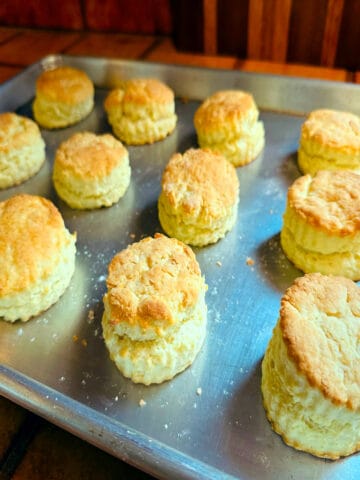 Finished cream biscuits on a metal baking sheet.