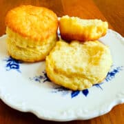 Cream biscuits on a white plate with blue flowers.