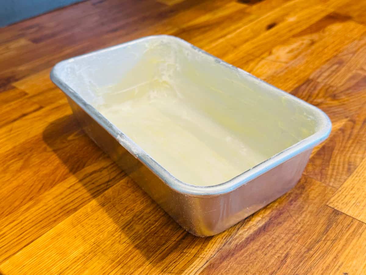Greased and floured aluminum loaf pan.