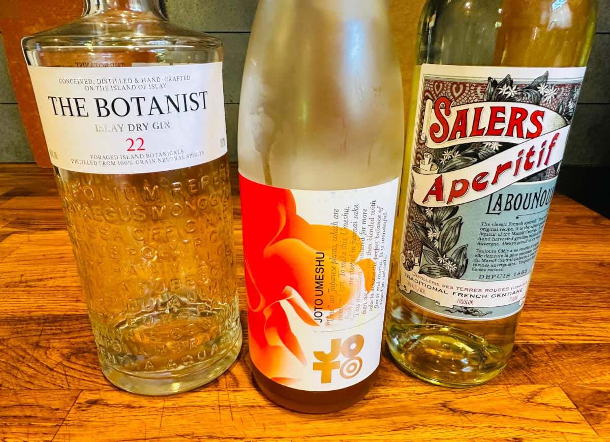 A bottle of gin, a bottle of umeshu sake, and a bottle of Salers.