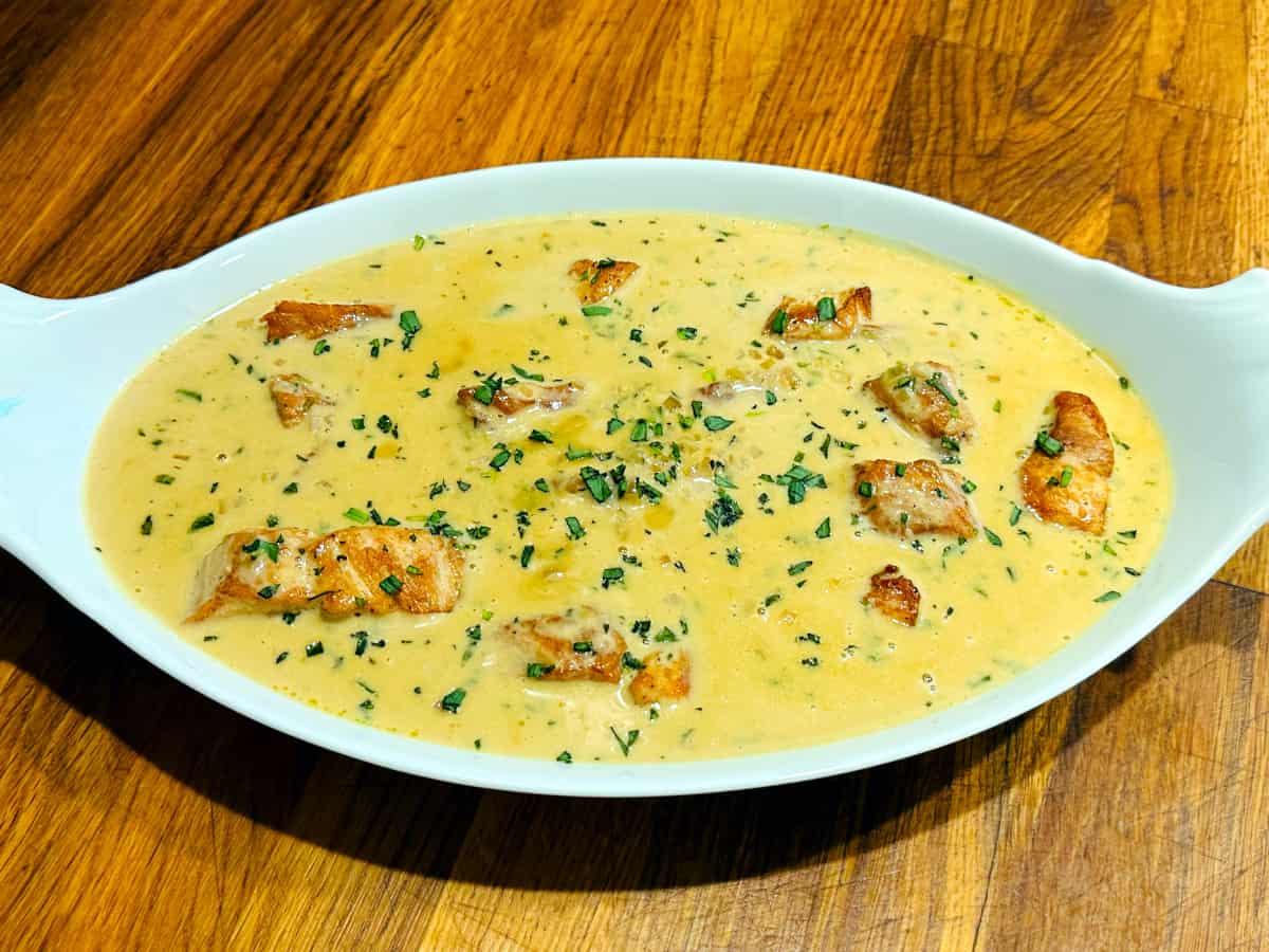 Chicken tarragon in an oval white serving dish.