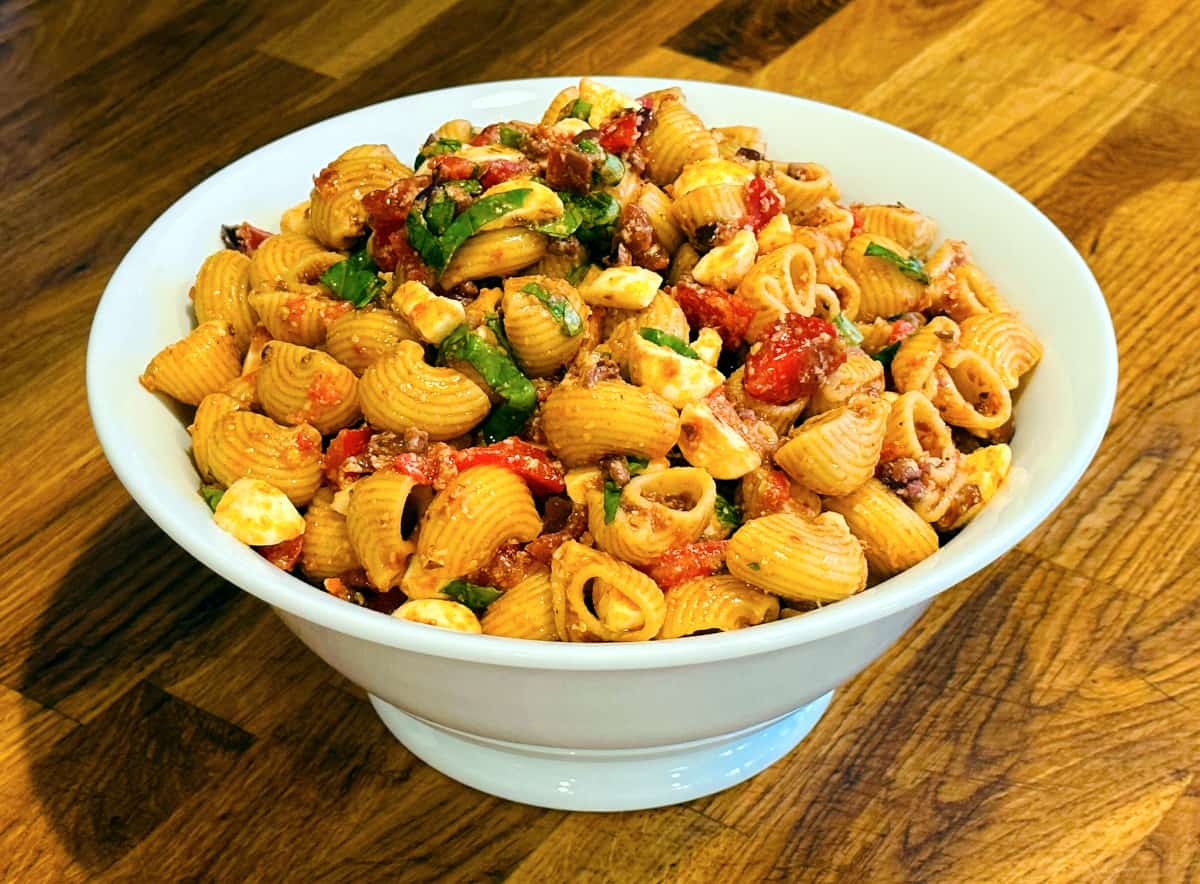 Summer pasta salad in a large white serving bowl.