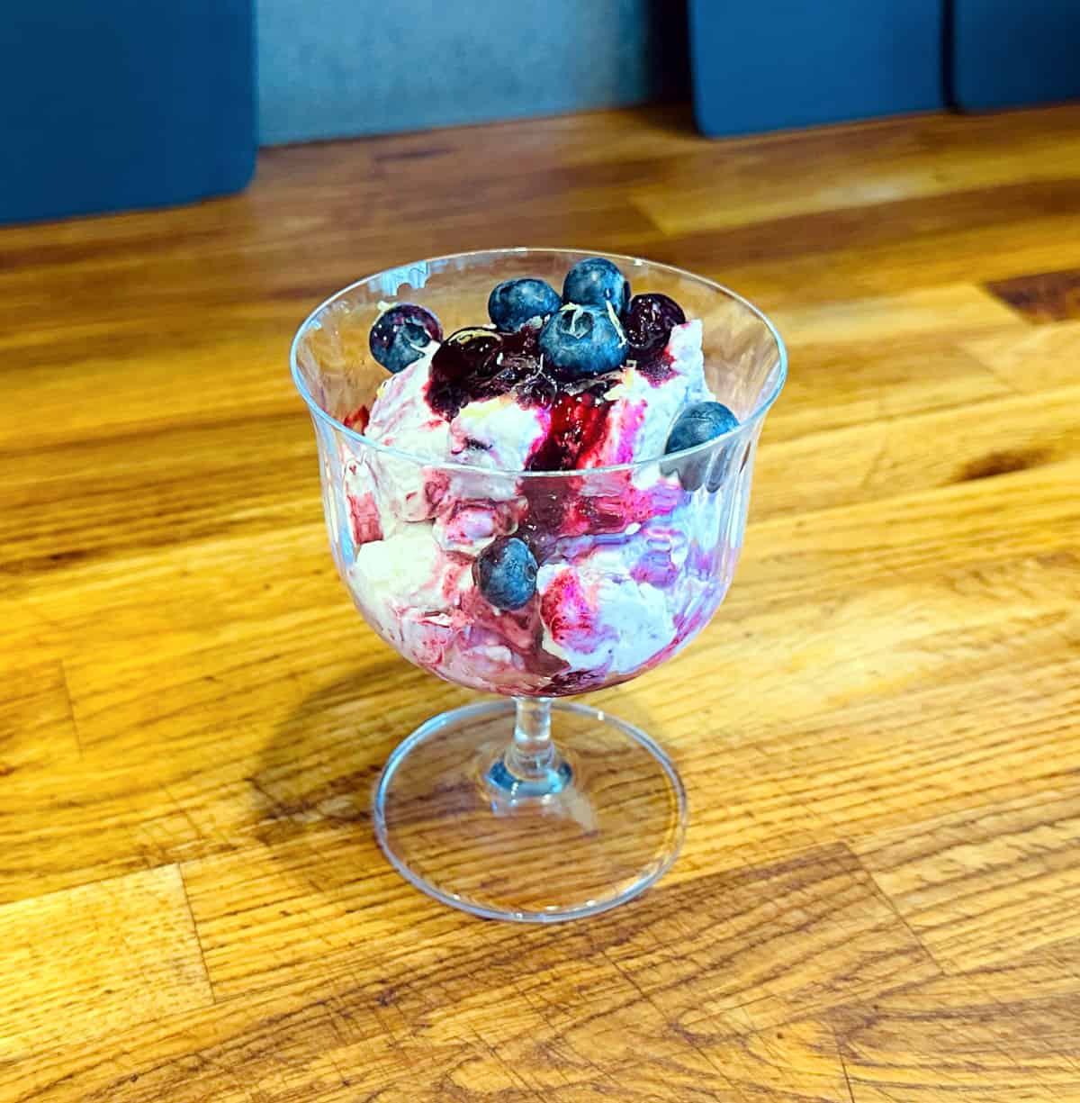 Blueberry fool in a coupe glass.