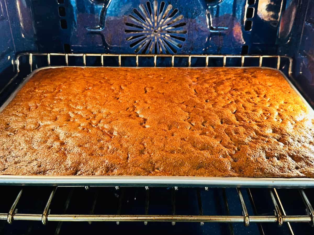A pan of chocolate zucchini bars baking in a blue oven.