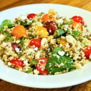 Mediterranean couscous and lentil salad served in a shallow white bowl.