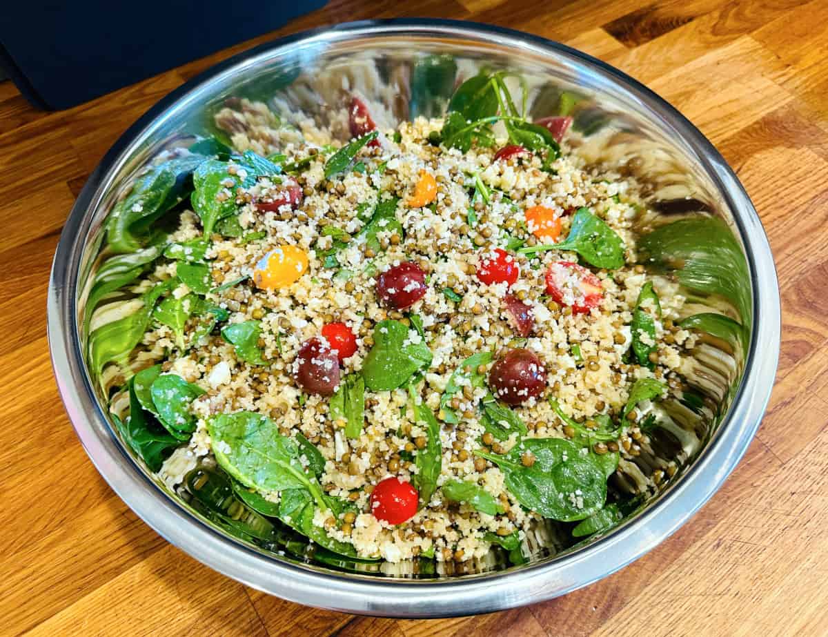 Mediterranean couscous and lentil salad in a large steel bowl.