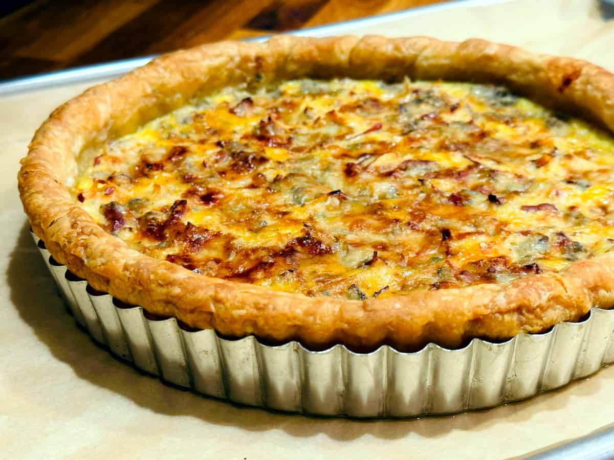 Gorgonzola apple quiche cooling in a tart pan.