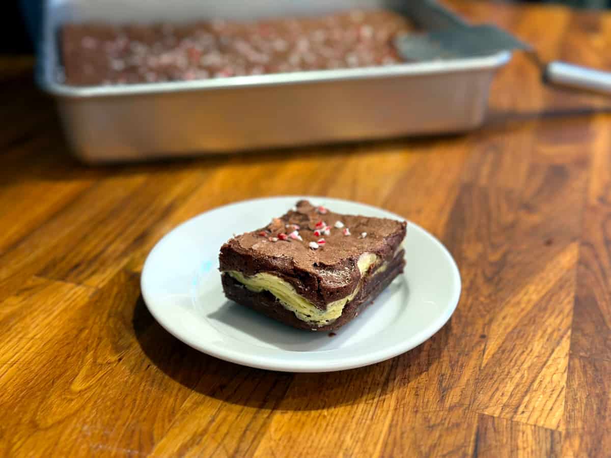 Peppermint cream cheese brownie on a small white plate.
