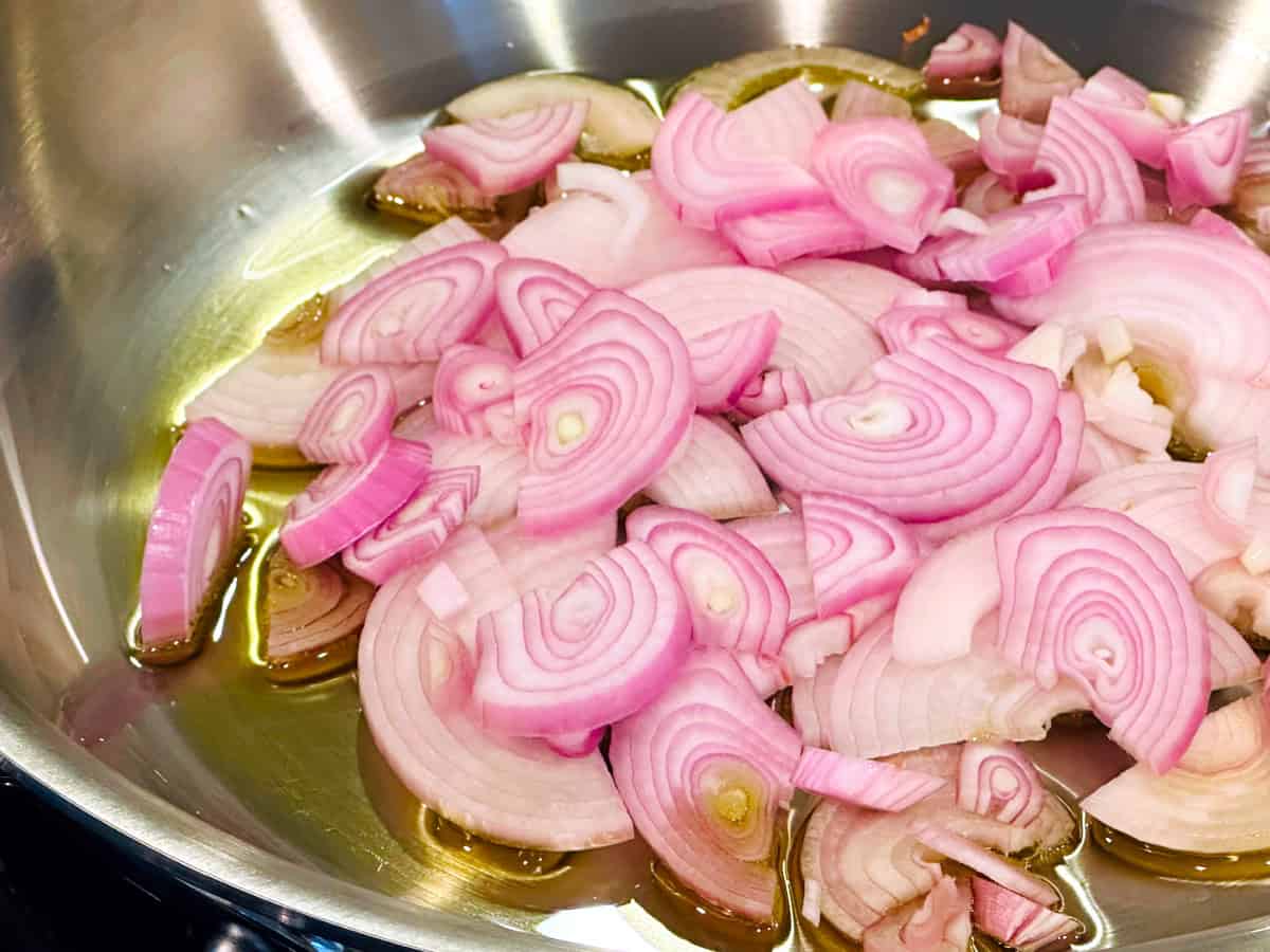 Chopped shallots and olive oil in a steel skillet.