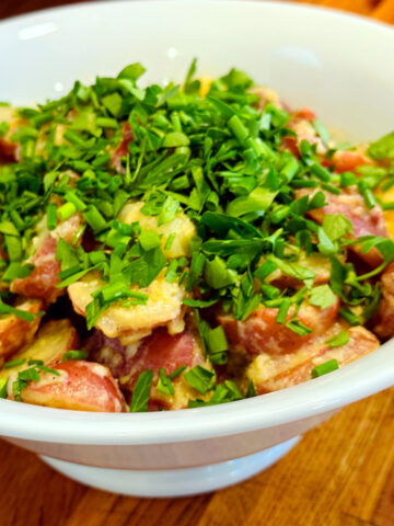 French potato salad in a white dish.