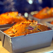 Miniature loaves of rhubarb bread baking in a blue oven.