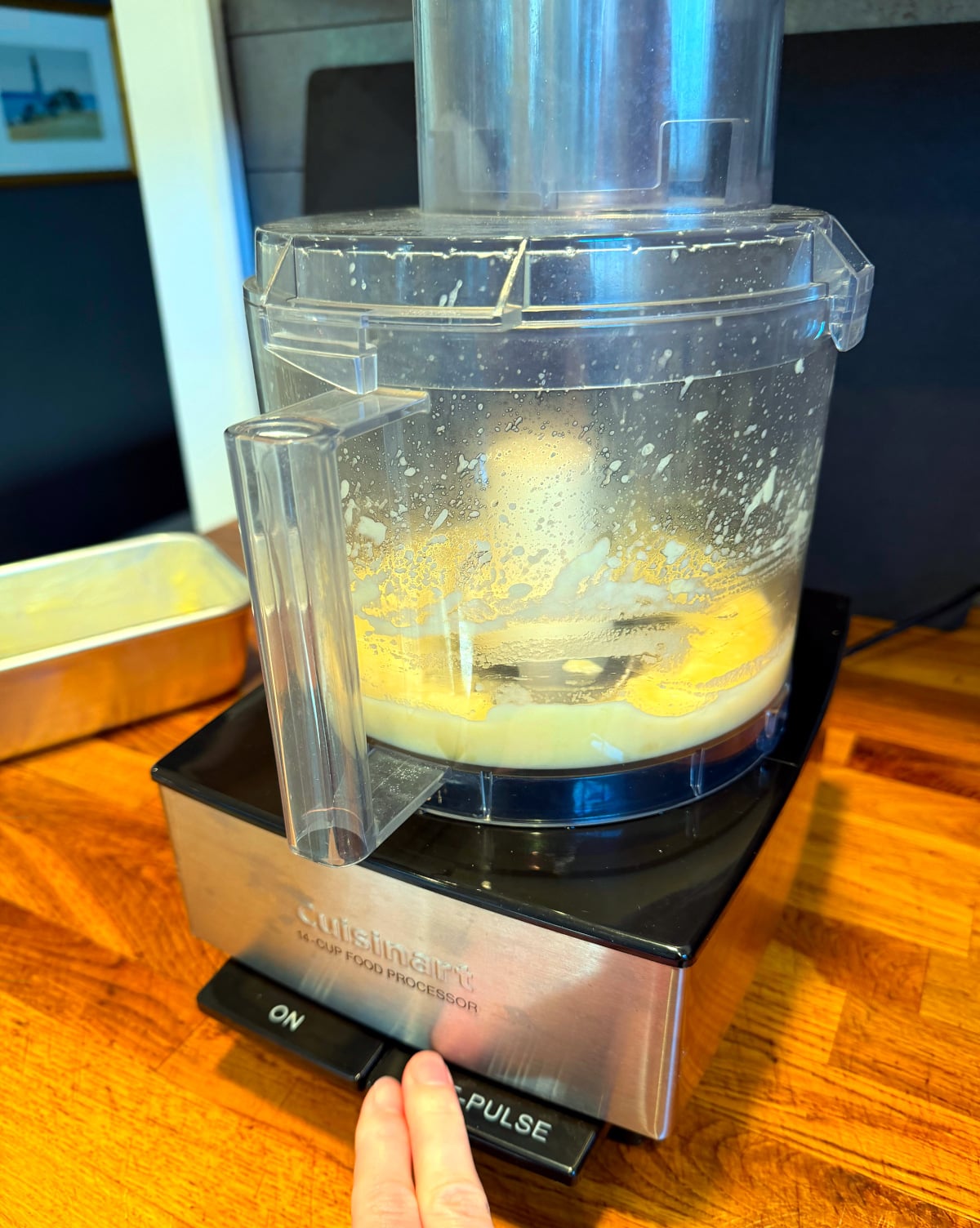 Pureeing cooked apple in food processor.